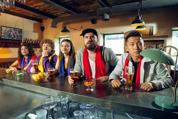 Los aficionados al deporte animando en el bar, pub y beber cerveza mientras que el campeonato, la competencia va — Foto de Stock