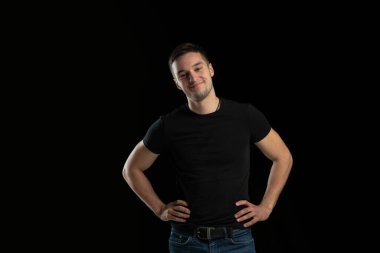 Siyah stüdyo arka planında beyaz bir gencin tek renkli portresi.