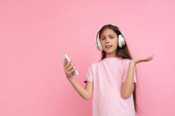 Портрет белой девушки на фоне розовой студии, концепция эмоций — стоковое фото