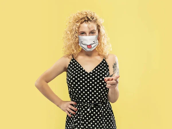 Portrait of young caucasian woman with emotion on her protective face mask — Stock Photo, Image