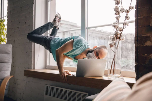 Joven haciendo yoga en casa mientras está en cuarentena y trabajando por cuenta propia — Foto de Stock