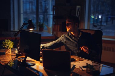 Coronavirus ya da COVID-19 karantinasında tek başına çalışan bir adam gece geç saatlere kadar kalıyor.