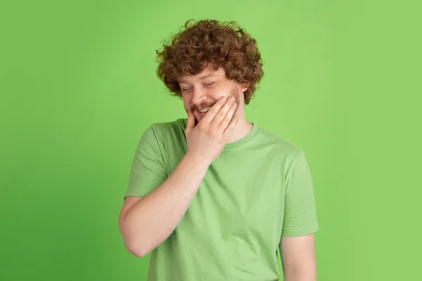 Caucasian young mans monochrome portrait on green studio background — Stock Photo, Image