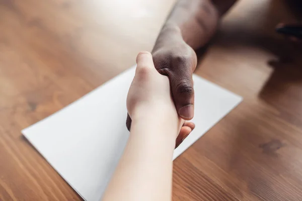 Close up of african-american male and caucasian female hands, working in office — Stock Photo, Image
