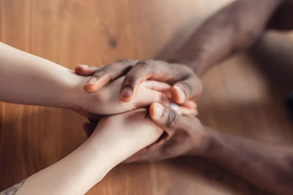 Close up of african-american male and caucasian female hands holding — Stock Photo, Image