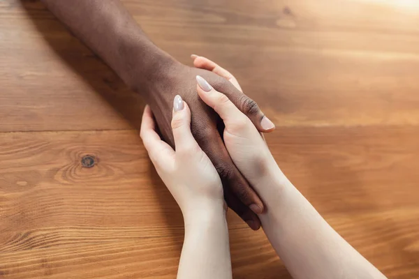 Close up of african-american male and caucasian female hands holding — Stock Photo, Image