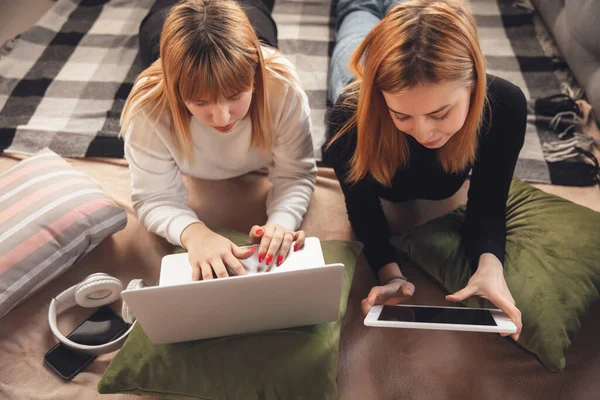 Young friends, women using gadgets to watch cinema, photos, online courses, taking selfie or vlog, top view