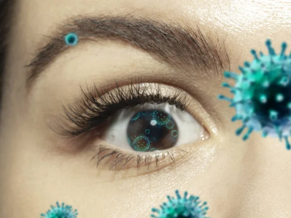 Close up shoot of a female eye with 3D-illustrated coronavirus models, the way of infecting — Stock Photo, Image