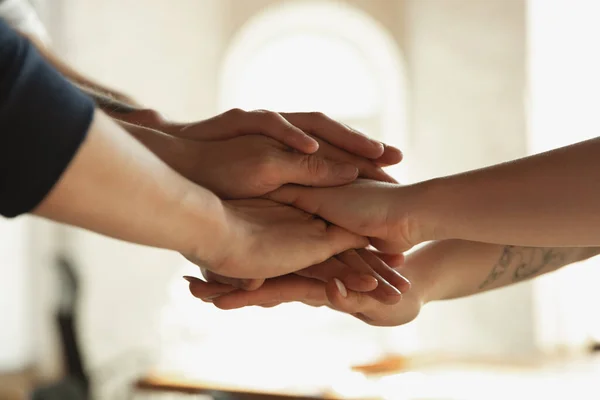 Primer plano de las manos caucásicas masculinas y femeninas, cubriéndose mutuamente, equipo, amistad, negocios — Foto de Stock