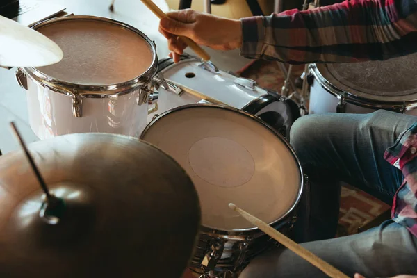 Caucasian musician playing drumms during online concert with the band at home isolated and quarantined, inspired improvising, close up