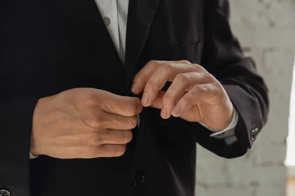Close up of caucasian male hands, wearing classic black jacket — Stock Photo, Image