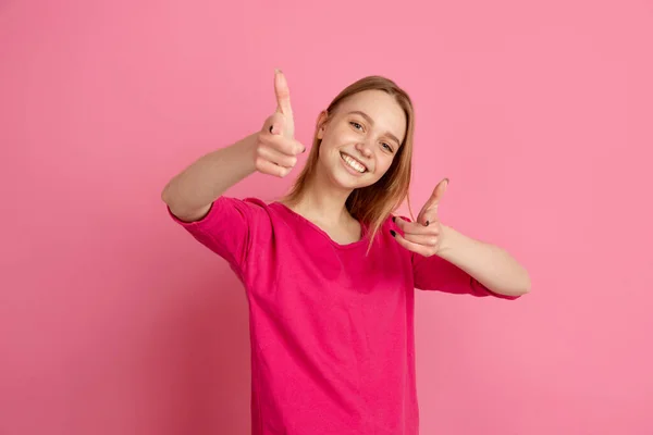 Caucasian young womans monochrome portrait on pink studio background, emotinal and beautiful — Stock Photo, Image