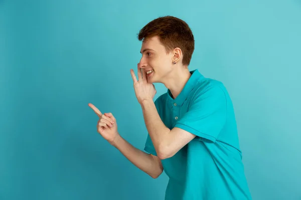 Caucasian young mans monochrome portrait on blue studio background, emotinal and beautiful — Stock Photo, Image