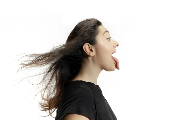 Smiling girl opening her mouth and showing the long big giant tongue isolated on white background, crazy and attracted — Stock Photo, Image