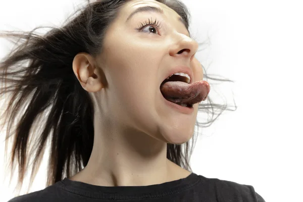 Smiling girl opening her mouth and showing the long big giant tongue isolated on white background, crazy and attracted — Stock Photo, Image