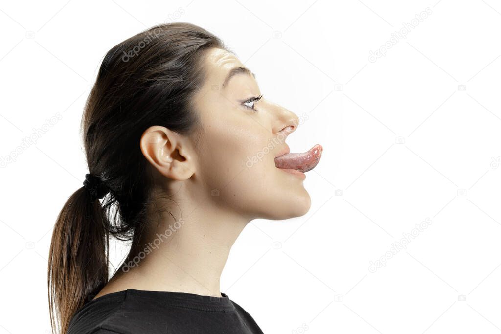 Smiling girl opening her mouth and showing the long big giant tongue isolated on white background, crazy and attracted