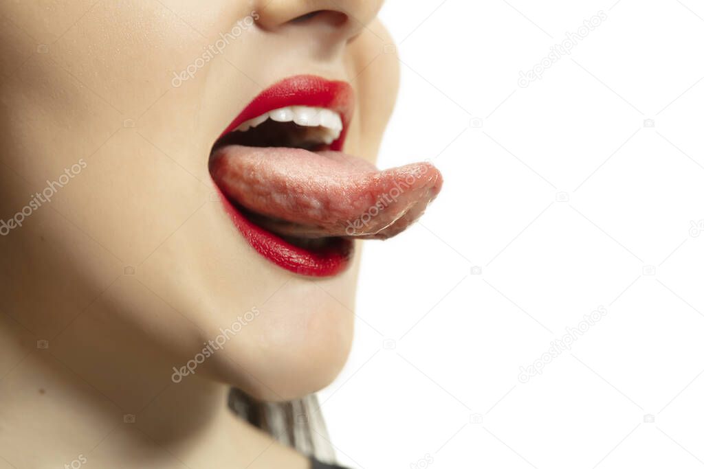 Smiling girl opening her mouth with red lips and showing the long big giant tongue isolated on white background, crazy and attracted, close up