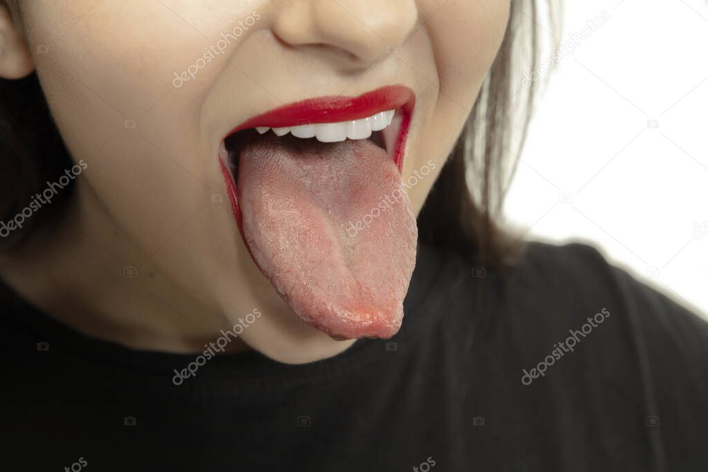 Smiling girl opening her mouth with red lips and showing the long big giant tongue isolated on white background, crazy and attracted, close up