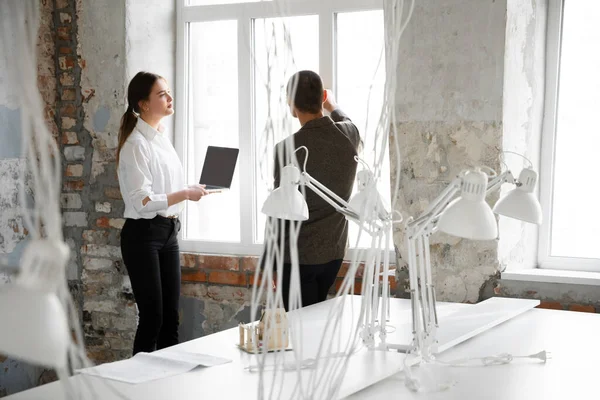 Female estate agent showing new home to a young man after a discussion on house plans, moving, new home concept