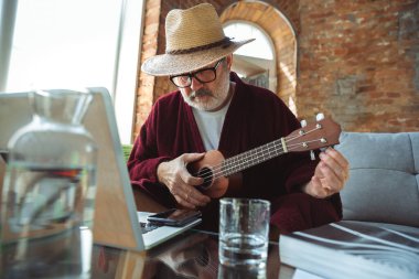 Karantina sırasında olgun yaşlı bir adam virüs salgını sırasında evde kalıp Monte Carlo 'da online gitar çalma dersleri almanın ne kadar önemli olduğunu fark ediyor.