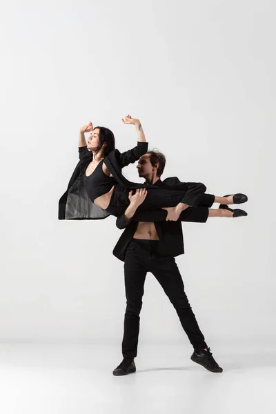 Young and graceful ballet dancers in minimal black style isolated on white studio background — Stock Photo, Image