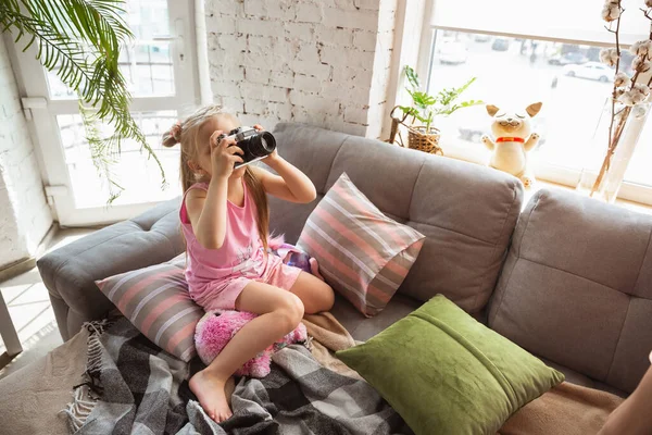 Κοριτσάκι που παίζει σε ένα υπνοδωμάτιο με χαριτωμένο πιτζάμα, στυλ στο σπίτι και άνεση, τραβώντας μια φωτογραφία, διασκεδάζοντας — Φωτογραφία Αρχείου