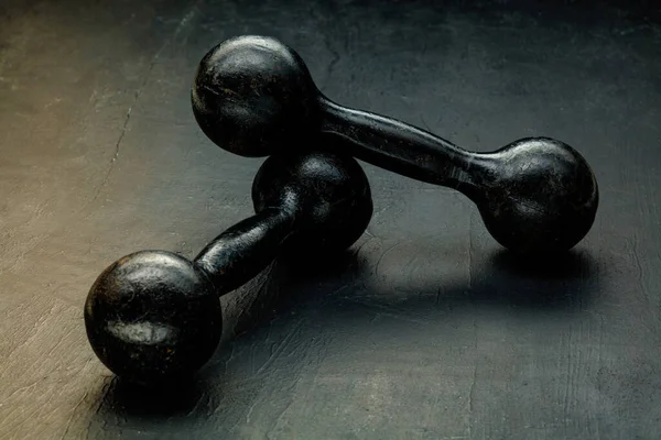 Professional sport equipment isolated on black studio background. Black gym weights.