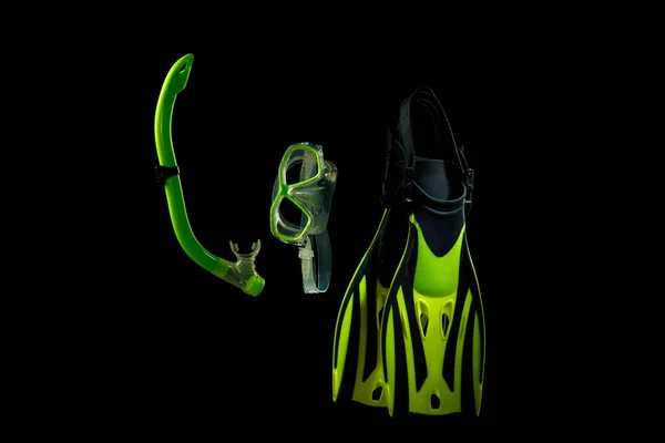 Professional sport equipment isolated on black studio background. Swimming flippers and mask.