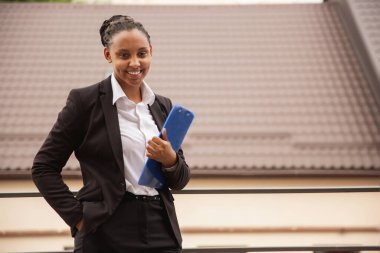 African-american businesswoman in office attire smiling, looks confident and happy, successful clipart