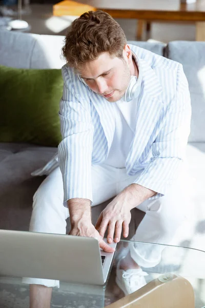 Caucasian man during online concert at home isolated and quarantined, impressive improvising, listening to band playing