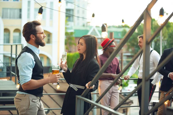 Group of young caucasian people celebrating, look happy, have corporate party at office or bar — Stock Photo, Image