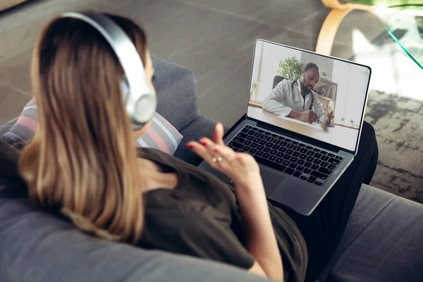 Young woman getting online medical help and advice during videocall with doctor checking symtoms aand explaining the drugs reciepes — Stock Photo, Image
