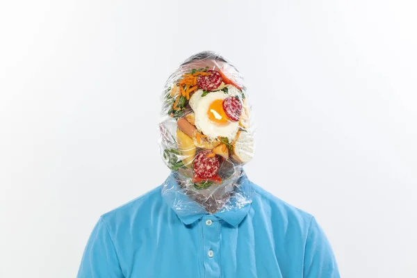 Male face covered with oilcloth, cellophane and unhealthy food, hard to breathe. People lost their faces, cant notice the environmental pollution made by themself. — Stock Photo, Image