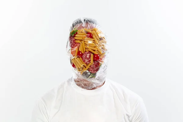Male face covered with oilcloth, cellophane and unhealthy food, hard to breathe. People lost their faces, cant notice the environmental pollution made by themself. — Stock Photo, Image