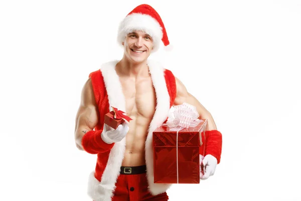 Sexy fitness Santa Claus holding a red boxes — Stock Photo, Image