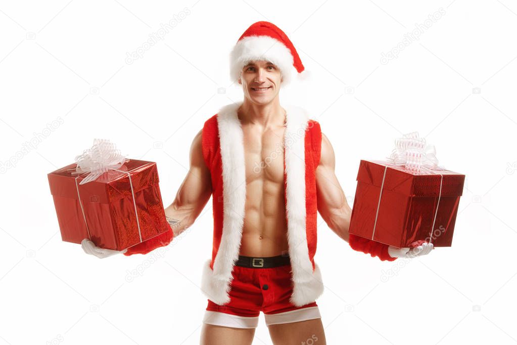 Sexy fitness Santa Claus holding a red boxes