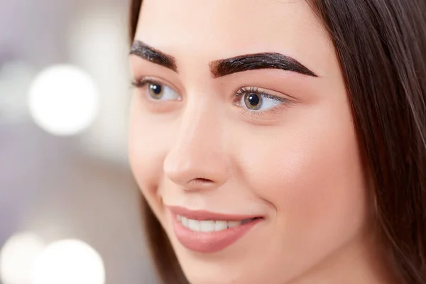 Girl during procedure of permanent make up of eyebrows. — Stock Photo, Image