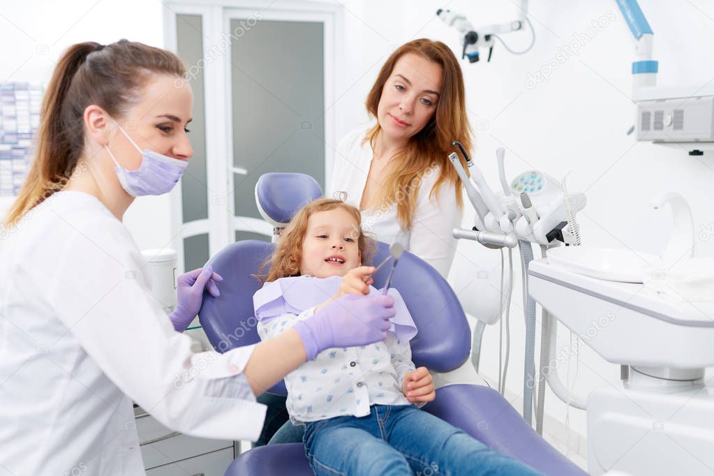 Dentists examining little girl