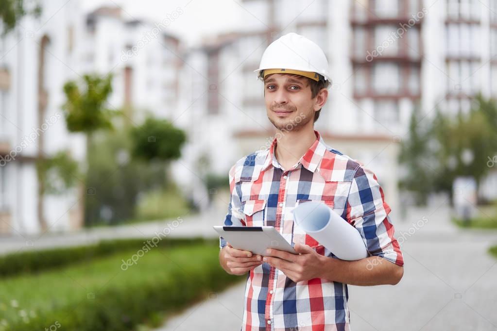 Young architect in front of apartment building