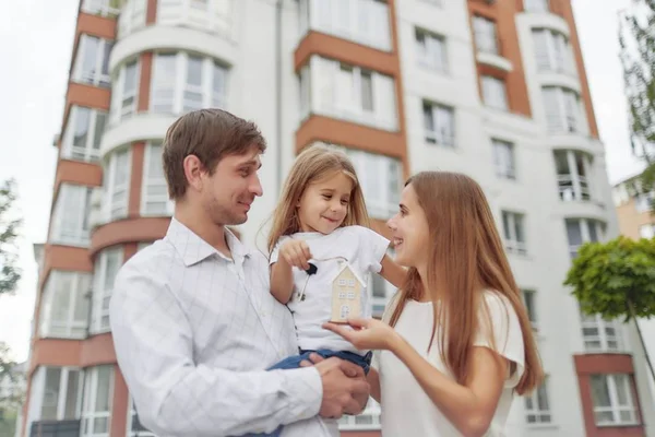 Happy family in front of new apartment building — Stock Photo, Image