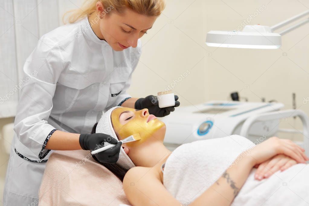 Cosmetologist doing beauty procedure for patient.