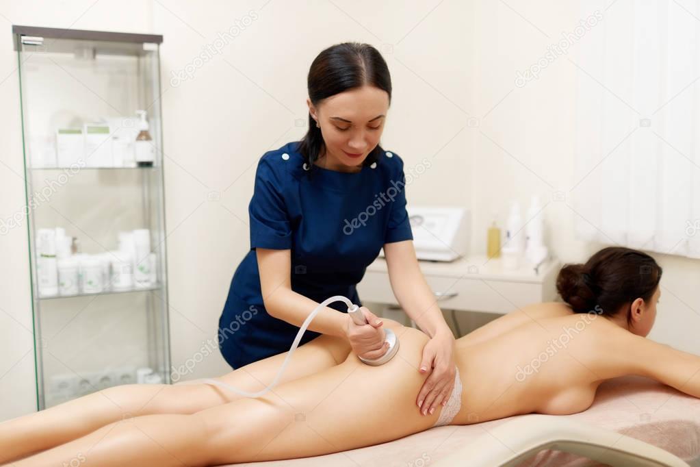 Hardware cosmetology. Young woman getting rf lifting procedure in a beauty parlour.