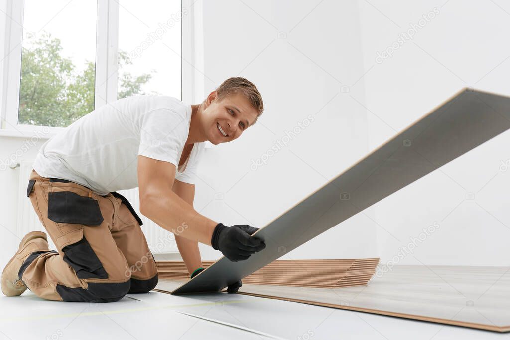 Laying laminate flooring. Floor installation: Close up of New Laminate Floor