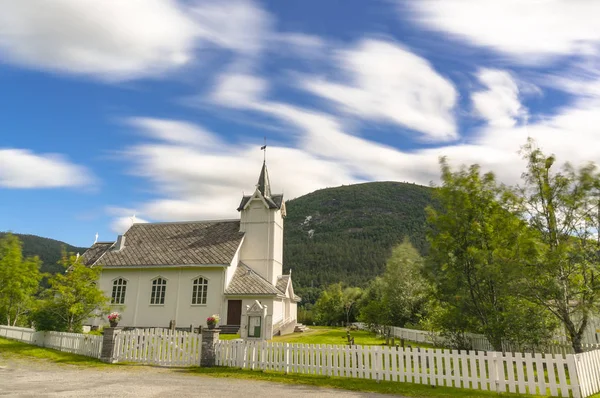 Wooden church surrounded by white fence — Stock Photo, Image