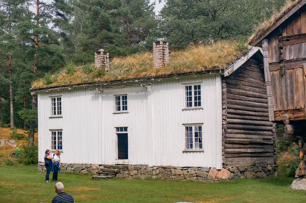 White old building with boards, green roof — Stock Photo, Image