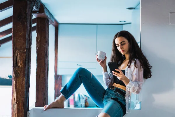 Woman relaxing with phone in morning — Stock Photo, Image