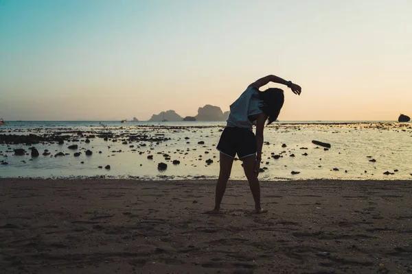 Girl training in twilight on beach — Stock Photo, Image