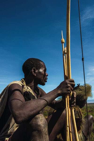 Eyasi lake, Tanzania, november, 23, 2019: African hunter with bow and arrows Stock Picture