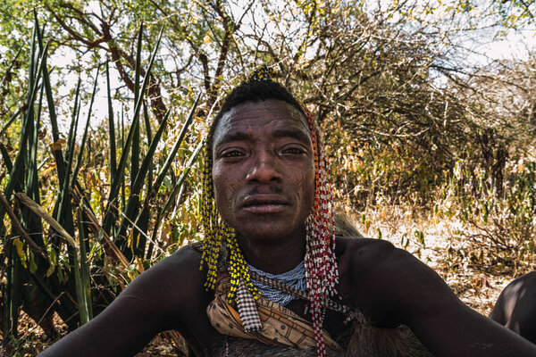 Eyasi lake, Tanzania, november, 23, 2019: African hunter with head ornaments Stock Picture