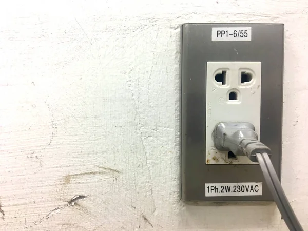 Electric current plug on the cement wall